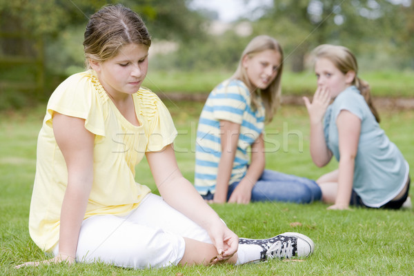 Two young girls bullying other young girl outdoors Stock photo © monkey_business