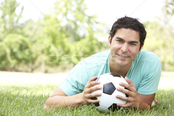 Zdjęcia stock: Portret · młody · człowiek · parku · piłka · nożna · człowiek · ogród