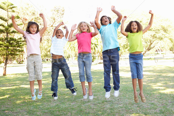 Stock photo: Group Of Children Jumping In Air In Park