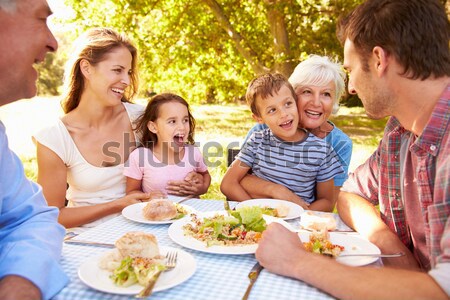 Family Decorating Easter Eggs On Table Outdoors Stock photo © monkey_business
