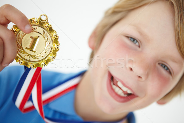 Young boy showing off medal Stock photo © monkey_business