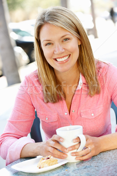 Stock photo: Woman sitting at sidewalk caf