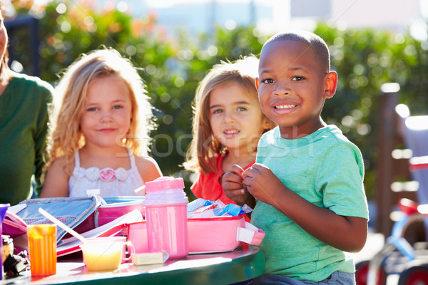 Elementary Pupils Sitting At Table Eating Lunch Stock photo © monkey_business
