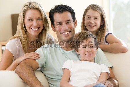 Stock photo: Family sitting in living room smiling