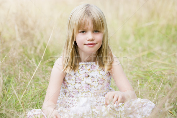 Young girl sitting outdoors smiling Stock photo © monkey_business