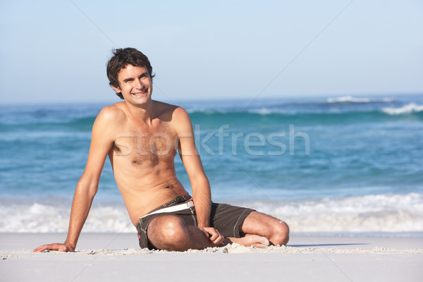 Fiatal fürdőruha ül homokos tengerpart család férfi Stock fotó © monkey_business