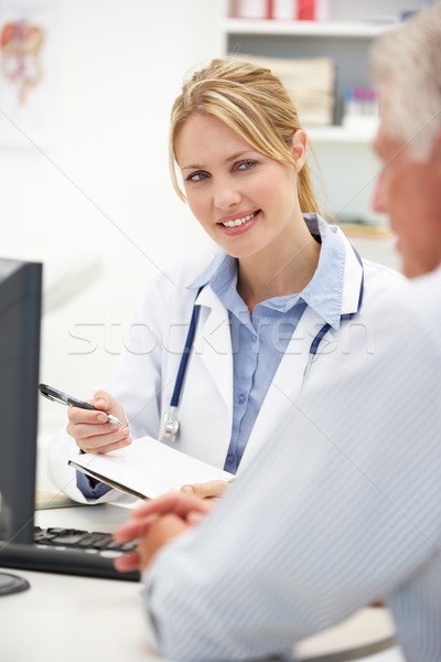 Young doctor with senior patient Stock photo © monkey_business
