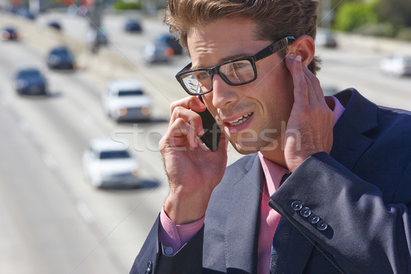 Businessman Speaking On Mobile Phone By Noisy Freeway Stock photo © monkey_business