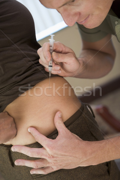 Man helping woman inject drugs to achieve pregnancy Stock photo © monkey_business