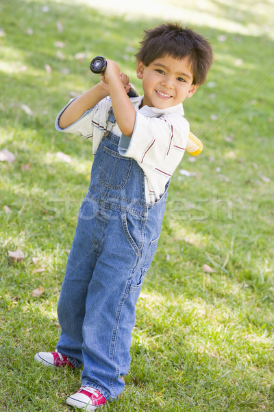 Young boy holding baseball bat outdoors smiling Stock photo © monkey_business