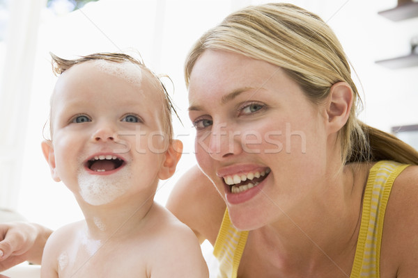 Mother giving baby bubble bath smiling Stock photo © monkey_business