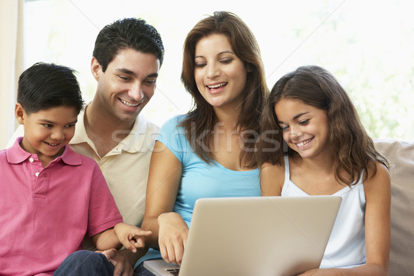 Stock photo: Family Sitting On Sofa At Home With Laptop