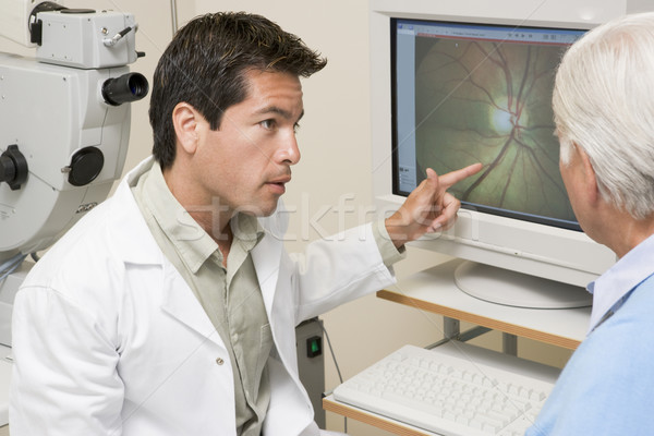 Stock photo: Doctor Explaining Eye Exam Results To Patient