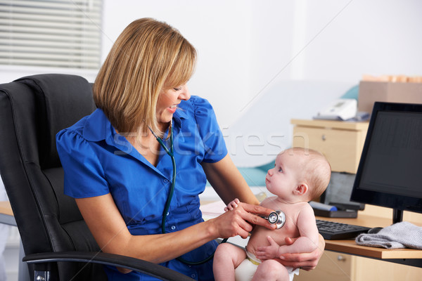UK doctor examining baby Stock photo © monkey_business