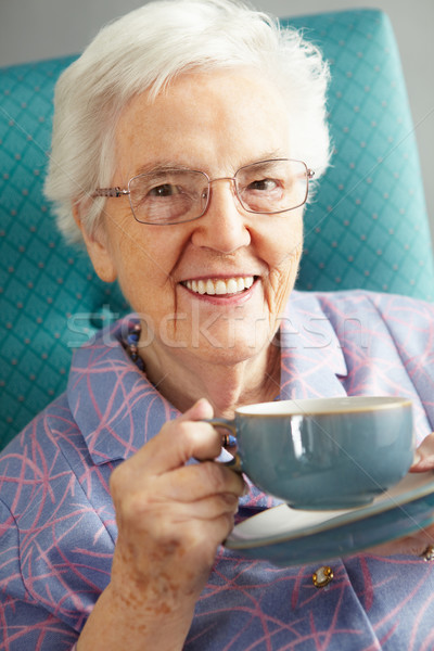 Senior mulher relaxante cadeira bebida quente beber Foto stock © monkey_business
