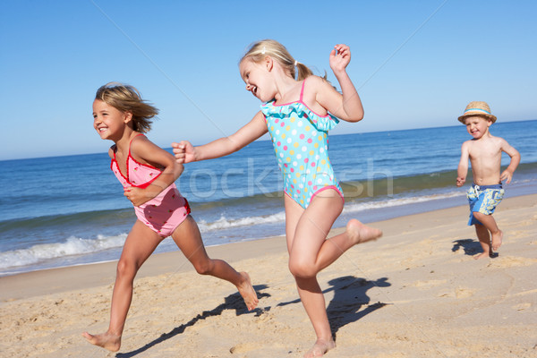Three Children Running Along Beach Stock photo © monkey_business