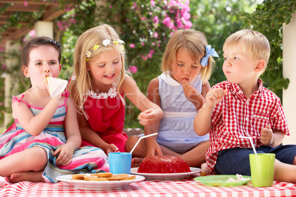 Group Of Children Eating Jelly At Outdoor Tea Party Stock photo © monkey_business