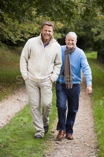 Adult father and son walking along path Stock photo © monkey_business
