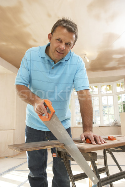 Builder Sawing Wood On Workbench Stock photo © monkey_business