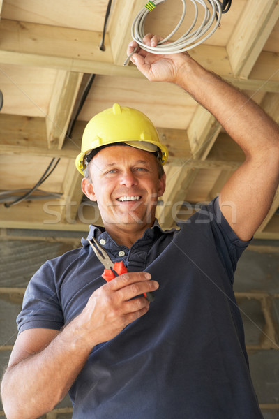 Stock photo: Electrician Working On Wiring In New Home