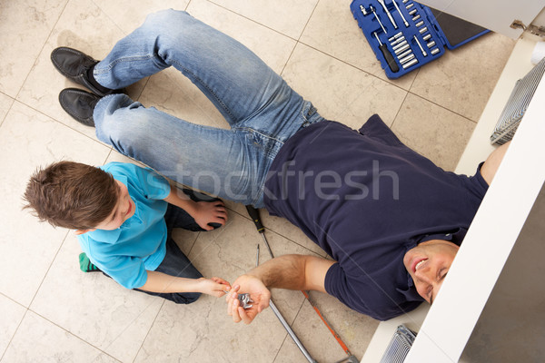Son Helping Father To Mend Sink In Kitchen Stock photo © monkey_business