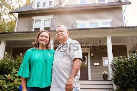 Senior Hispanic couple outside home Stock photo © monkey_business