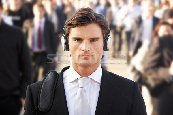 Male commuter in crowd wearing headphones Stock photo © monkey_business