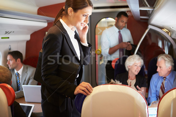 Imprenditrice cellulare occupato pendolare treno donna Foto d'archivio © monkey_business