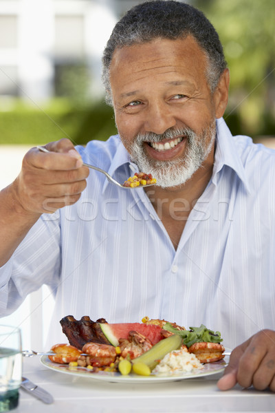 Középkorú férfi ebéd freskó kert asztal tányér Stock fotó © monkey_business