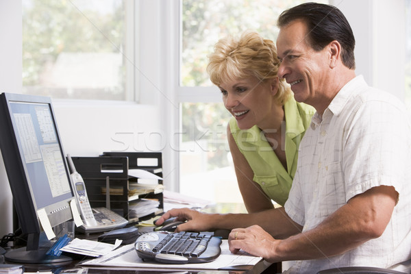 Couple in home office at computer smiling Stock photo © monkey_business