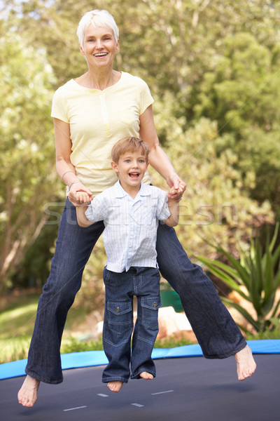 Grandmother And Grandson Jumping On Trampoline In Garden Stock photo © monkey_business