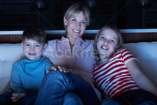 Mother And Children Watching Programme On TV Sitting On Sofa Tog Stock photo © monkey_business