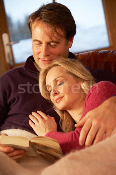 Middle Aged Couple Relaxing On Sofa In Chalet With Winter View Stock photo © monkey_business