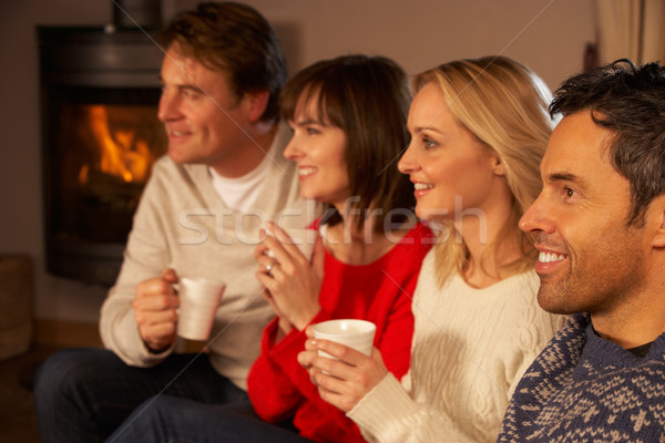 Group Of Middle Aged Couples Sitting On Sofa With Hot Drinks Wat Stock photo © monkey_business