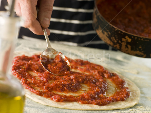 Spooning Tomato sauce onto a Pizza Base Stock photo © monkey_business
