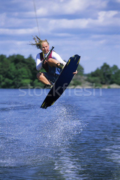 Stock photo: A young woman water skiing