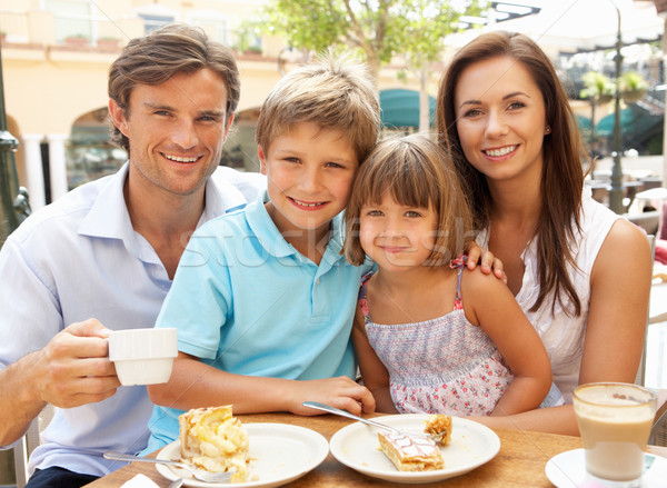 Young Family Enjoying Cup Of Coffee And Cake In Caf Stock photo © monkey_business