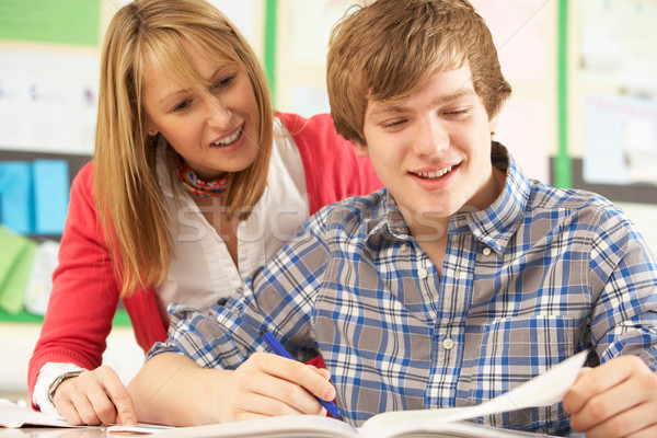 Male Teenage Student Studying In Classroom With Teacher Stock photo © monkey_business