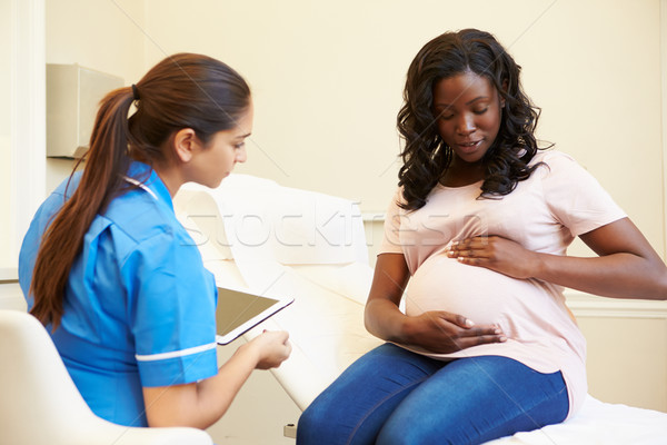 Stock photo: Nurse Using Digital Tablet In Meeting With Pregnant Woman