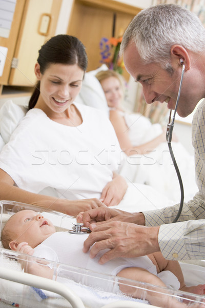 Doctor checking baby's heartbeat with new mother watching and sm Stock photo © monkey_business