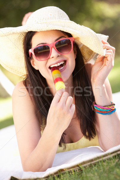 Woman Relaxing In Garden Eating Ice Lolly Stock photo © monkey_business