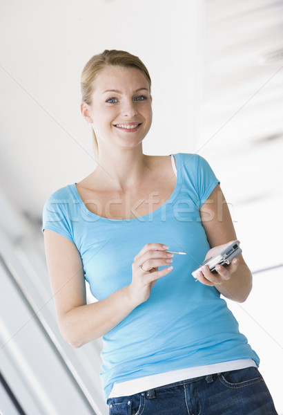 Mulher em pé corredor pessoal digital assistente Foto stock © monkey_business