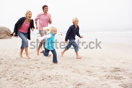Family Having Fun On Winter Beach Stock photo © monkey_business