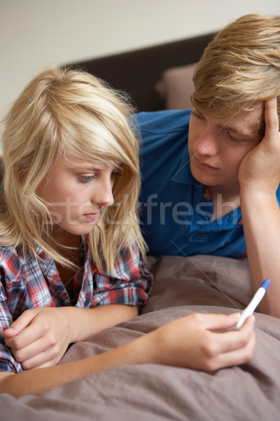 Two Teenage Girls Lying On Bed Looking At Pregnancy Testing Kit Stock photo © monkey_business