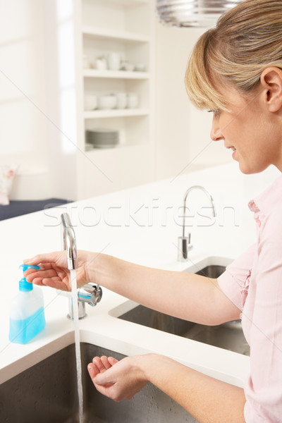 Woman Washing Hands At Kitchen Sink Stock photo © monkey_business