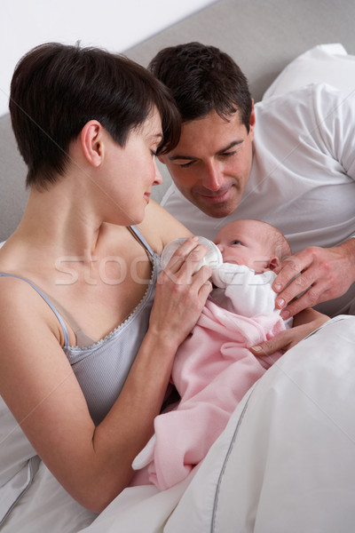 Parents Feeding Newborn Baby In Bed At Home Stock photo © monkey_business