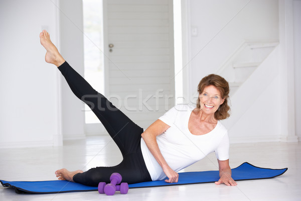 Senior woman exercising in home gym Stock photo © monkey_business