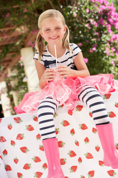 Young Girl Wearing Pink Wellington Boots Drinking Milkshake Stock photo © monkey_business