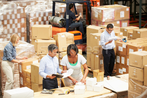 Stock photo: Workers In Warehouse Preparing Goods For Dispatch