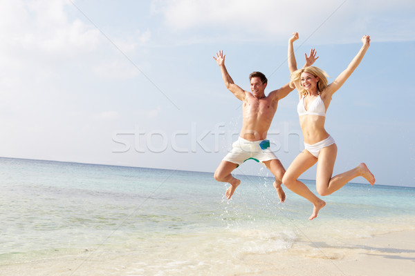 Couple Jumping In The Air On Tropical Beach Stock photo © monkey_business